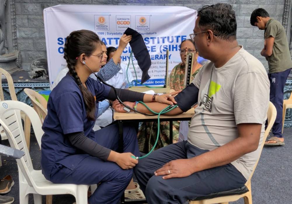 Physiotherapy students and faculty from Suryadatta College of Physiotherapy providing healthcare services during Ganesh Chaturthi physiotherapy camps for community members.