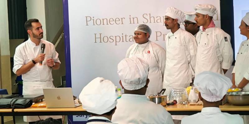 International Chef Alexandre Morado demonstrating special dessert preparation to hospitality students at Suryadatta College.